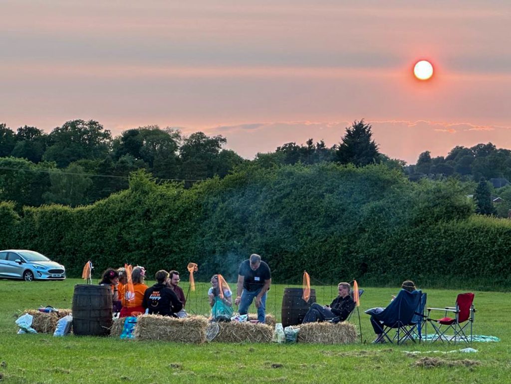 Campfire at sunset on the field at Samadhi Fest