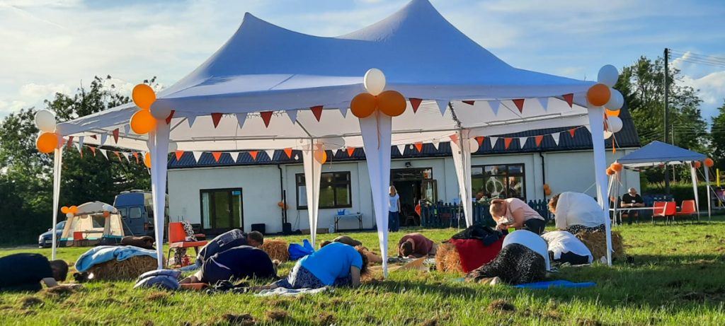 Yoga under the marquee with the hall behind