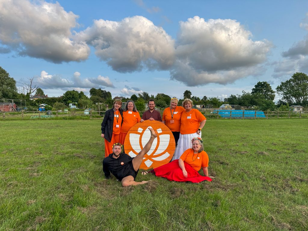 The Samadhi Fest team with the lotus sign on the field