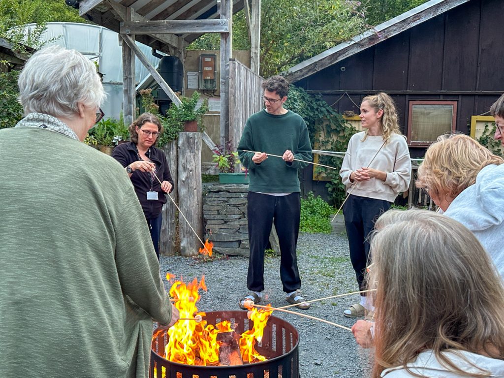 Retreat guests around the campfire in the evening