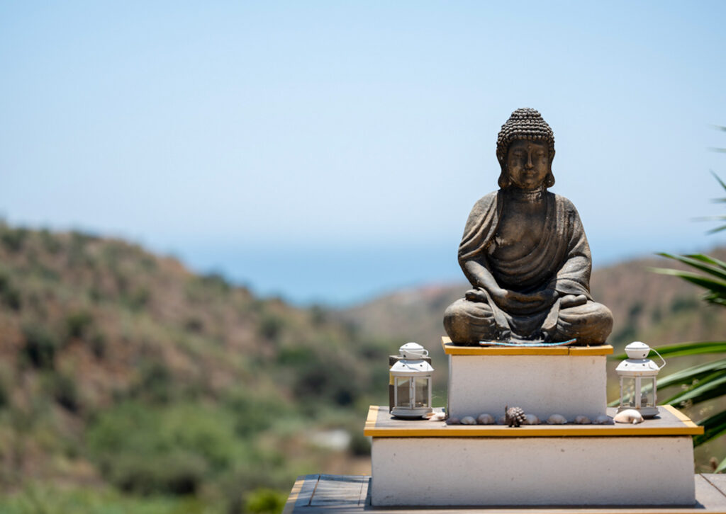 Buddha statue with the sea beyond