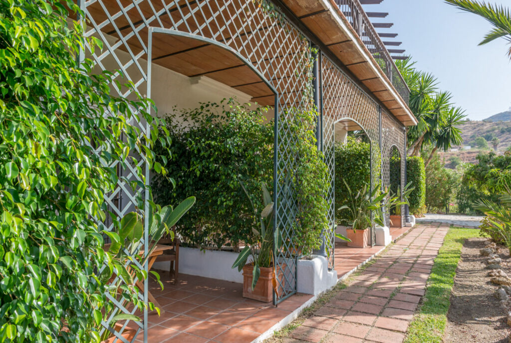 The trellised walkway and hills behind Santillan