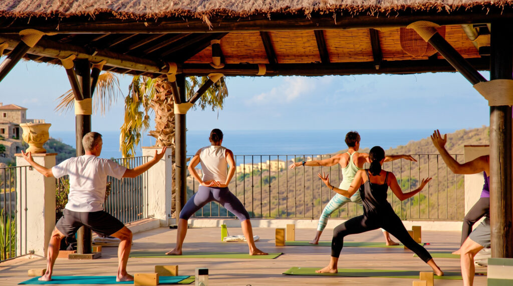 Morning yoga on the terrace looking out to the sea
