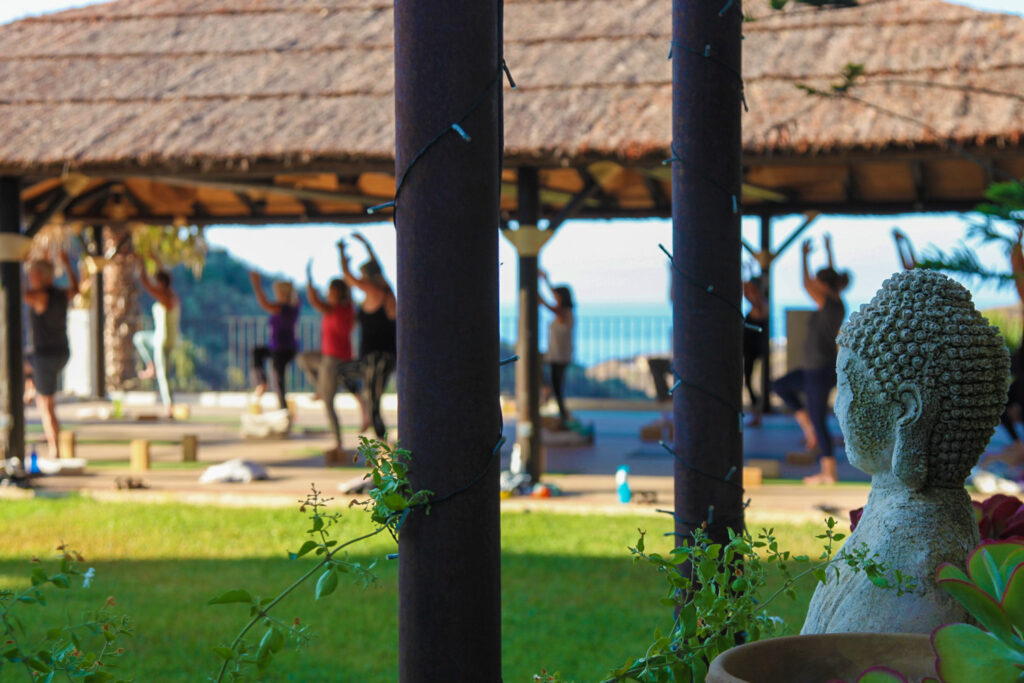 Yoga under the thatched garden sala